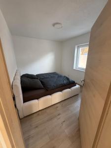 a bedroom with a bed and a couch in a room at Loft05 in Wankham