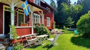 a red house with a flag on the front of it at Lägenhet Strömsberg C in Strömsberg +9 photos