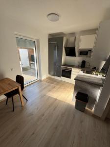 a living room with a kitchen and a table at Loft05 in Wankham