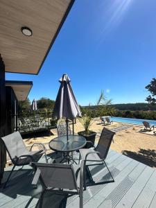 a patio with a table and chairs and a pool at Tordos Lodge in Quintero