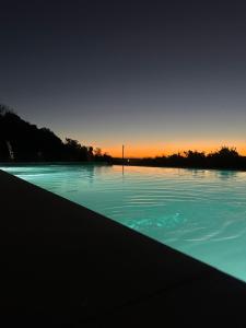 a large body of water with the sunset in the background at Tordos Lodge in Quintero