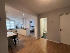 a kitchen and living room with a table and a dining room at Clock in Gheorgheni +8 photos