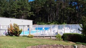 a house with a swimming pool with a fence at Inn at Otter Crest in Otter Rock
