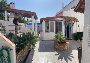a patio with potted plants and a house at Shell's Apartment in Praia do Carvoeiro