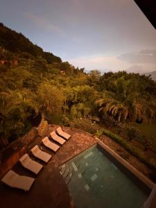 a swimming pool with two lounge chairs next to a swimming pool at Casa Valdres in Santa Cruz La Laguna