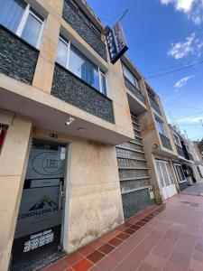 a building with a sign over the door at Hotel Cordillera Real in Sogamoso