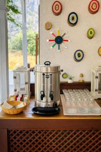 a blender sitting on top of a table with glasses at Bybassios Orhaniye in Orhaniye