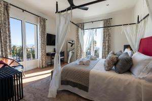 a bedroom with a bed and a large window at Hotel Duquesa Golf Club in San Luis de Sabinillas