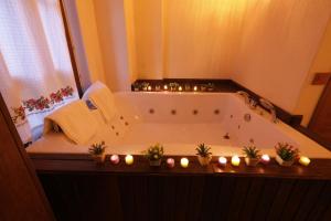 a bathroom with a bath tub with candles in it at İkiz Konaklar in Selçuk +50 photos