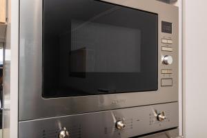 a large silver microwave oven with a black screen at Heatherstone Haven in Midrand