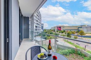 a table with a bottle of wine on a balcony at Heatherstone Haven in Midrand