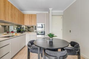 a kitchen with a table and chairs in a kitchen at Heatherstone Haven in Midrand