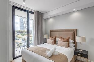 a bedroom with a large bed and a balcony at Heatherstone Haven in Midrand +30 photos
