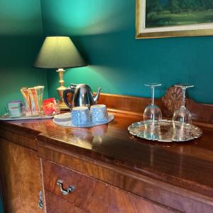 a wooden counter with a tea pot and glasses on it at Bromwich Guest House - 250m to town centre! in Blackwood