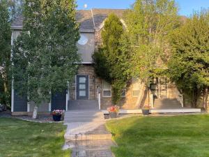 a house with a blue door and a grass yard at Lehi East Bench Private Studio! in Lehi