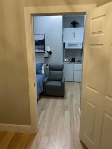 a living room with a chair and a kitchen at Lehi East Bench Private Studio! in Lehi +8 photos