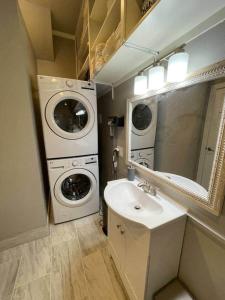 a bathroom with a sink and a washer and dryer at Lehi East Bench Private Apt! in Lehi