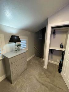 a room with a desk with a lamp and a window at Lehi East Bench Private Apt! in Lehi
