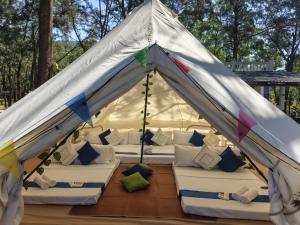 a white tent with white couches and pillows at Puerto Silanguin Beach Resort in Subic +54 photos