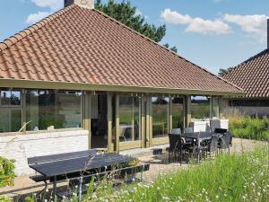 a gazebo with a table and chairs in a yard at 5 person holiday home on a holiday park in Karrebæksminde in Karrebæksminde