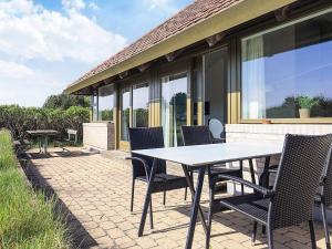 a table and chairs sitting on a patio at 5 person holiday home on a holiday park in Karrebæksminde in Karrebæksminde