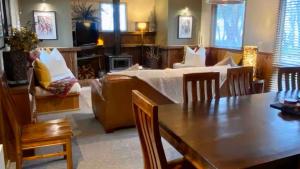 a living room with a bed and a table and a couch at Highlander in Dinner Plain