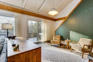 a living room with a couch and a table at Resort-Style Community! Quechee Chalet w/ Deck in Quechee