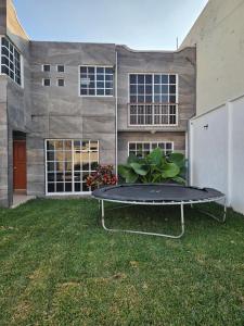 a trampoline in a yard in front of a building at Las fincas Jiutepec in Jiutepec