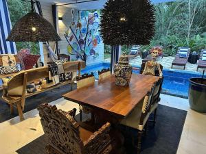 a dining room with a wooden table and chairs at Casa Azul-Xpuha, Tulum, Mexico in Xpu Ha
