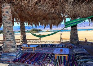 a hammock and a table on a beach with a hammock at Dagal Camp - دجل كامب in Sharm El Sheikh +20 photos