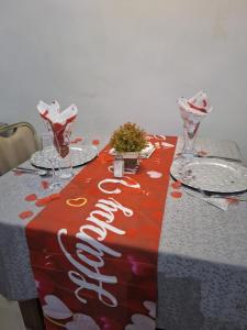 a table with a red and white table cloth with wine glasses at Dopad Hills Hotel and Suites in Ojo +23 photos
