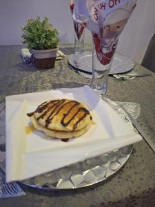 a white plate with a tortilla on a table at Dopad Hills Hotel and Suites in Ojo