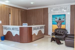a lobby with a reception desk and a chair at Erraha Hostel Dakhla in Dakhla
