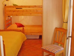 a bedroom with a bunk bed and a chair at Barolo in Gravedona +32 photos
