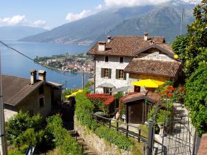 a house on a hill with a view of the water at Barolo in Gravedona