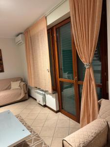 a living room with a couch and a sliding glass door at Karen Sofia Modern Appartament in Opera +8 photos