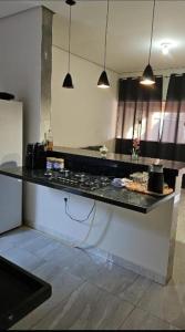 a kitchen with a black counter top in a room at JMS Refuge in Pirapora