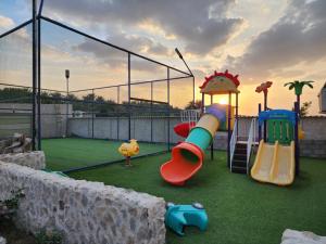 a playground with two slides and a play structure at استراحة ريف حتا in Hatta