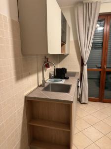 a kitchen counter with a sink and a window at Karen Sofia Modern Appartament in Opera