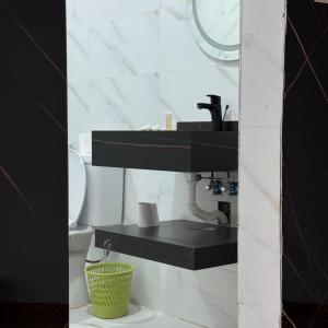 a bathroom with a sink and a toilet at Elite Rum Camp in Disah