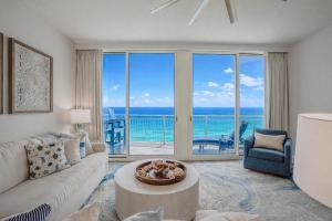 a living room with a couch and a table at Ocean Blue at 1805 Aqua in Panama City Beach