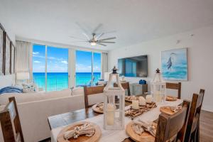 a dining room with a table and a couch at Ocean Blue at 1805 Aqua in Panama City Beach