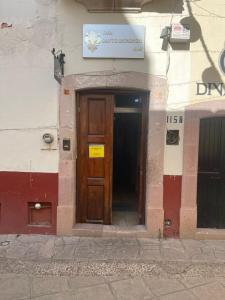 a door to a building with a sign above it at Hotel Santo Domingo in Zacatecas