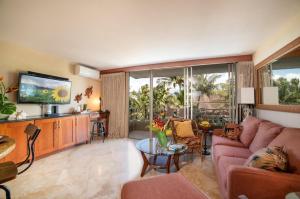 a living room with a couch and a tv at Nani Kai Hale 308 in Kihei
