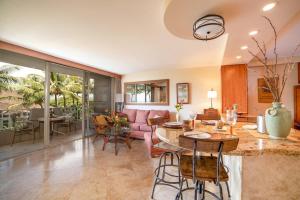 a living room with a table and a couch at Nani Kai Hale 308 in Kihei