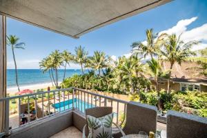 a balcony with a view of the beach and the ocean at Nani Kai Hale 308 in Kihei