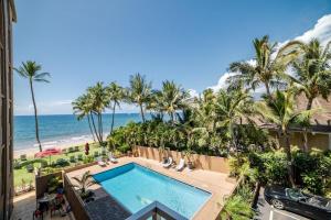 a view of a swimming pool and the beach at Nani Kai Hale 308 in Kihei