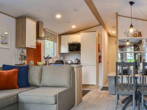 a living room with a couch and a kitchen at Willow - Uk36374 in Westward