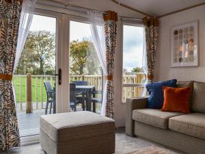 a living room with a couch and a balcony at Willow - Uk36374 in Westward