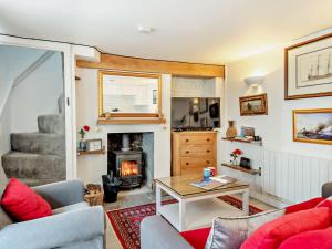 a living room with a couch and a fireplace at 2 Bed in Holt oc-78478 in Blakeney
